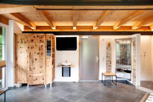 a room with a wooden door and a tv at Ferienhaus Plattner in Oetz