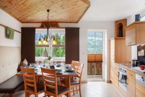 a kitchen and dining room with a table and chairs at Ferienhaus Plattner in Oetz