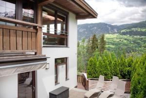 a balcony with chairs and a view of the mountains at Ferienhaus Plattner in Oetz