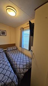 a small room with two beds and a window at Seagulls Sunrise in Seasalter +8 photos