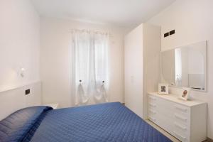 a bedroom with a blue bed and a white dresser at Antichi Ricordi - La Stalla in Marina di Andora +8 photos