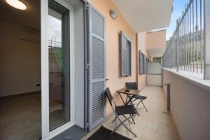 a balcony with two chairs and a table at Antichi Ricordi - La Stalla in Marina di Andora