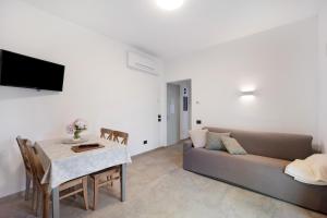 a living room with a couch and a table at Antichi Ricordi - La Stalla in Marina di Andora