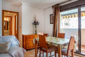 a dining room with a table and chairs at Apolo66-3 in Torrevieja
