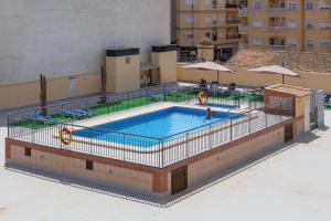 a swimming pool on top of a building at Apolo66-3 in Torrevieja