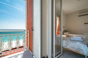 a room with a balcony with a view of the ocean at Angela sea view 4 in Kefallonia