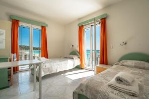 a bedroom with two beds and a view of the ocean at Angela sea view 4 in Kefallonia
