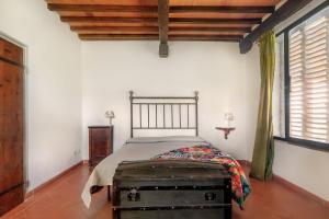 a bedroom with a bed with an old trunk at Universal Harmony - Capinera in Dicomano +21 photos