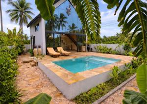 a swimming pool in the backyard of a house at Bahari Mirror Villas in Jambiani