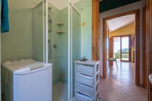 a bathroom with a washing machine and a shower at Domixedda in Costa Rei +22 photos