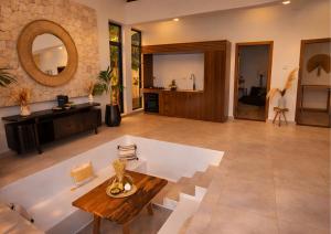 a large living room with a table and a tub at Bahari Mirror Villas in Jambiani