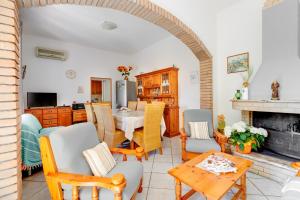 a living room with a table and chairs and a fireplace at Casa Rosa in Fluminimaggiore
