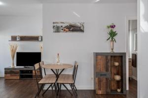 a dining room with a table and chairs and a tv at Casa Barriguita 2 in Playa Blanca