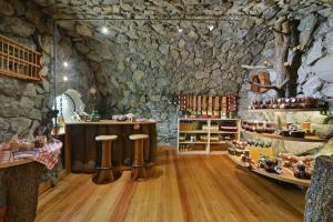 a wine tasting room with a stone wall at Birkenhof - Wohnung Ortler in Sluderno