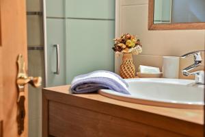 a bathroom with a sink and a mirror at Birkenhof - Wohnung Ortler in Sluderno
