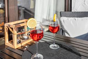 two glasses of red wine sitting on a table at Ferienwohnung Seebruck in Seebruck +14 photos