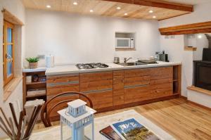 a kitchen with a sink and a stove at Sweet Somma Mountain Lodge 1 in San Guglielmo +17 photos