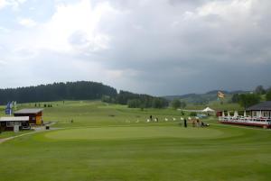 a golf course with people playing on a green at Ferienhaus Am Rösslewald in Breitnau