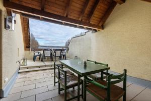 a patio with a table and chairs on a balcony at Untersee Appartements in Moos