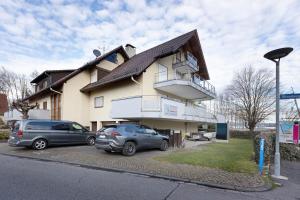 two cars parked in front of a building at Untersee Appartements in Moos