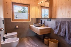 a bathroom with a sink and a toilet and a window at Landhaus Silene in Sarnonico +26 photos