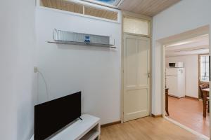 a living room with a flat screen tv on a wall at Ai Cannola - Calatafimi Segesta in Calatafimi