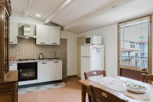 a kitchen with a table and a white refrigerator at Ai Cannola - Calatafimi Segesta in Calatafimi