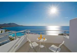 a balcony with a table and chairs on a yacht at Kaladi Rock Ammos in Avlemonas