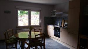 a kitchen with a table and a window and a table and chairs at Haus Moselschleife in Bremm