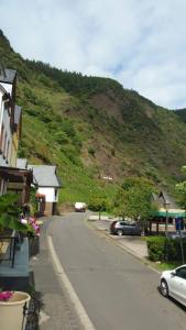 a street in a small town with a mountain at Haus Moselschleife in Bremm