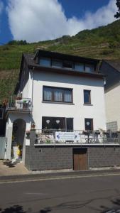 a white building with a balcony on the side of it at Haus Moselschleife in Bremm