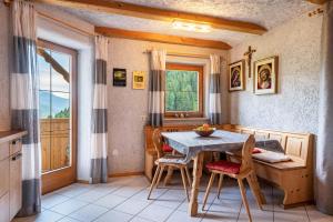 a kitchen with a table and chairs and a window at Eggerhof im Sarntal in Sarntal