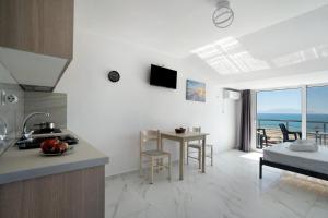 a kitchen and living room with a view of the ocean at Iguana studio 17 in Preveza