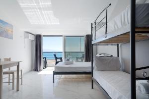 a bedroom with a bunk bed and a desk at Iguana studio 17 in Preveza