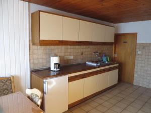a kitchen with a sink and a counter top at Waldblick in Gellersen