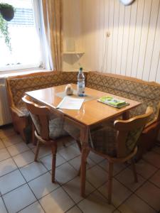 a table and chairs with a bottle of water on it at Waldblick in Gellersen