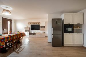 a kitchen and dining room with a table and a refrigerator at La Tavernetta di Elisa in Calimera +15 photos