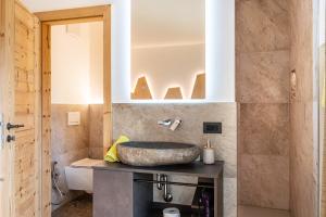 a bathroom with a sink and a mirror at Weirerhof Lebm Gspiarn in Barbiano +37 photos