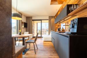 a kitchen and dining room with a table and chairs at Innerbachlerhof - Gantkofel in Postal