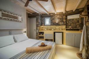 a bedroom with a bed with a hat on it at Villa Vagia in Vayiá +29 photos