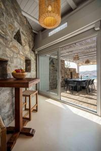 a dining room with a table and a glass door at Villa Vagia in Vayiá