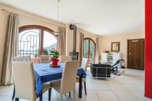 a dining room with a blue table and chairs at Casa Marina in Mergozzo