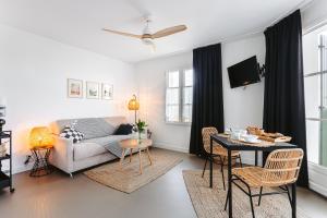 a living room with a couch and a table at Le Phare, Rivedoux Beach House in Rivedoux-Plage