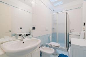 a white bathroom with a sink and a toilet at Dimora di Artemide in Otranto +21 photos