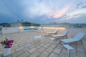 a patio with chairs and tables on a roof at Case Vacanze Otranto in Otranto