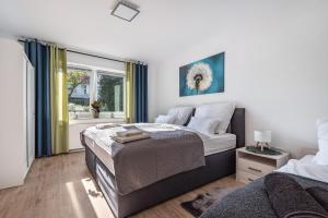 a bedroom with a large bed and a window at Ferienwohnung Deister Blick in Rodenberg