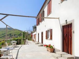 a courtyard of a house with tables and chairs at Fattorialmare Rossa in Camogli