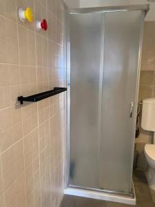 a shower with a glass door in a bathroom at Fattorialmare Rossa in Camogli