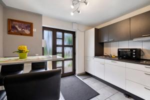 a kitchen with white cabinets and a counter top at Ruhig Wohnen in Sulz in Sulz am Neckar