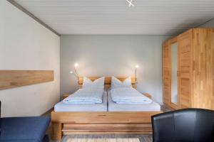 a bedroom with a bed with white sheets and pillows at Ruhig Wohnen in Sulz in Sulz am Neckar